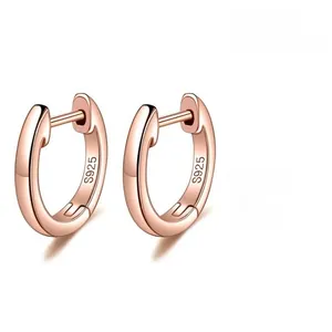 Vue détaillée du poinçon S925 sur les boucles d'oreilles créoles en or rose poli