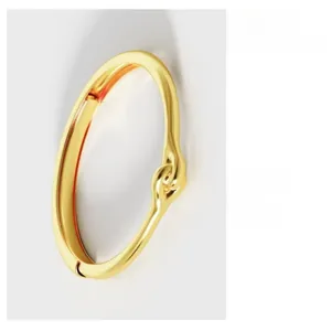 Close-up of golden knotted bracelet with minimalist intertwining design and polished finish