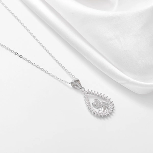 Sterling silver portrait pendant necklace with sparkling diamonds on white silk background