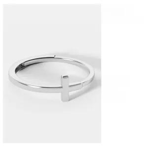 Detailed view of polished silver cross open ring featuring a minimalist aesthetic design