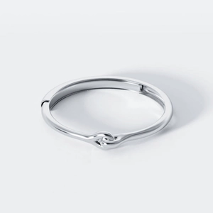 Polished silver knot ring with minimalist interlocking design and open adjustable band