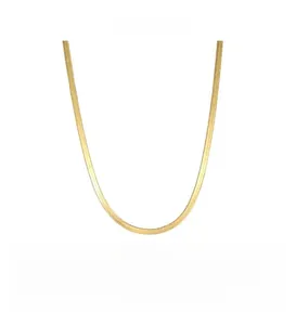 Detailed close-up of the flat golden herringbone chain showing its smooth metallic texture