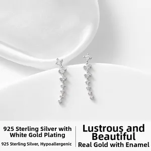 Detail of 925 sterling silver curved meteor earrings with sparkling cubic zirconia stones