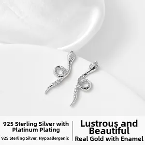 Macro view of 925 sterling silver snake stud earrings with white cubic zirconia stones