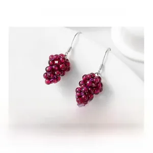 Macro shot of S925 sterling silver hooks on handmade garnet grape cluster earrings