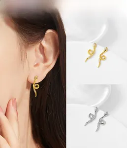 Close-up of snake-shaped silver earrings with sparkling white cubic zirconia pavé