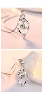 Close-up of S925 sterling silver twist pendant with zircon on ceramic bird display