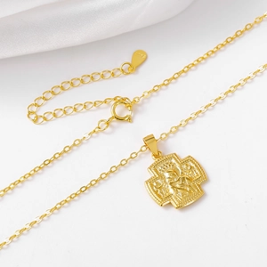 Detail of gold S925 sterling silver cross necklace with religious Madonna pendant detail