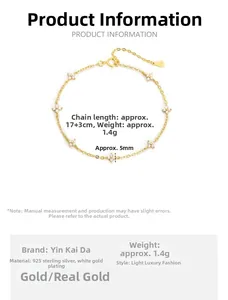 Detail of 925 sterling silver four-leaf clover bracelet with sparkling diamonds and gold finish