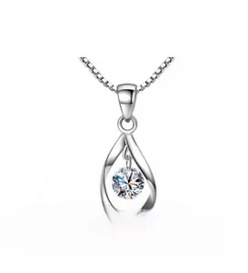 Macro detail of teardrop hollow pendant with center zircon on a silver chain