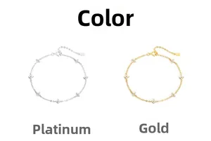 Close-up of silver and gold four-leaf clover bracelets with sparkling zircon stones