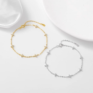Elegant S925 sterling silver four-leaf clover bracelet with sparkling zircons on white silk