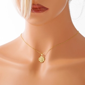 Elegant gold religious Virgin Mary cross pendant necklace worn on a model's neck