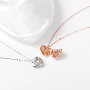 Detail eines S925 Silber- und Roségold-Herzmedaillons mit eingelegtem Zirkonstein
