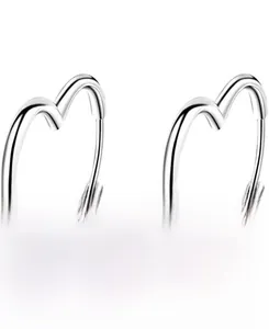 Detailed view of polished S925 sterling silver heart-shaped hoop earrings on white background