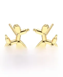 Detail of 925 sterling silver balloon dog stud earrings with a shiny gold mirror finish