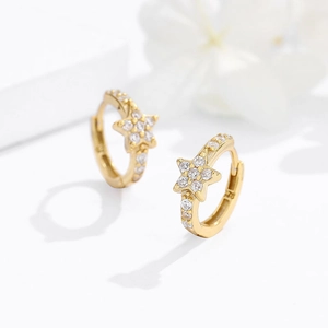 Elegant gold star hoop earrings featuring micro-paved cubic zirconia in a modern style