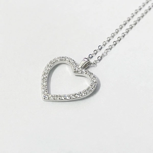 Vue macro du pendentif coeur en argent 925 avec zircons incrustés et design ajouré
