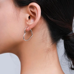 S925 sterling silver heart hoop earrings on a model showing minimalist fashion style