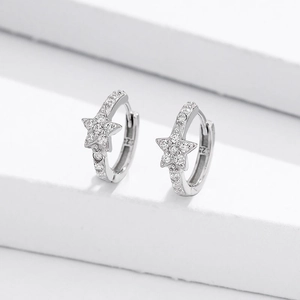 Macro shot of S925 sterling silver stamp and sparkling zircons on star hoop earrings