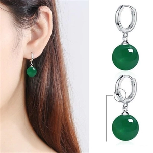 Detail of S925 sterling silver hoop earrings with dark green translucent stone beads