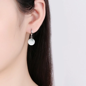 Vintage S925 sterling silver hoop earrings with a white cat eye stone bead for women