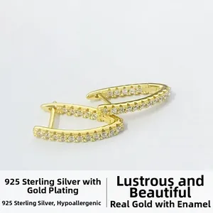 Detail of V-shaped gold-plated S925 sterling silver earrings set with micro-pave zircons