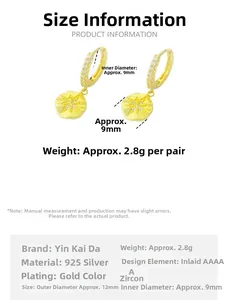 Detail view of 925 sterling silver gold hoop earrings with star zircon pendants