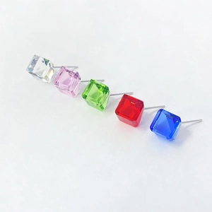 Macro detail of square-cut crystal stud earrings in five vibrant candy colors