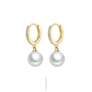 Detail of S925 sterling silver gold-plated hoop earrings with pearls and zircons