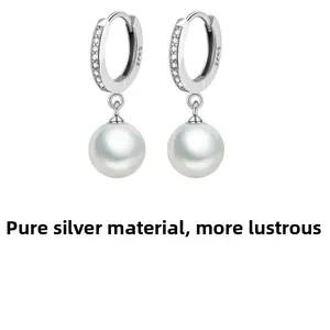 Close-up of S925 sterling silver pearl drop earrings with sparkling cubic zirconia inlay