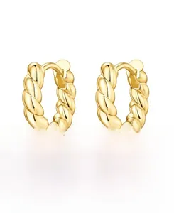 Macro detail of golden croissant style twist earrings in S925 sterling silver