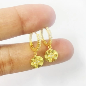 Elegant S925 sterling silver huggie earrings with gold-plated starburst medallions