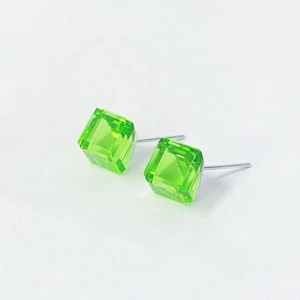 Macro shot of green sugar cube crystal stud earrings with polished s925 silver needles