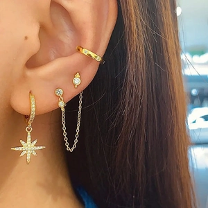 Gold s925 silver star earrings set with cubic zirconia featuring eight-pointed star charms