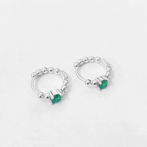 Detail of S925 sterling silver beaded hoop earrings with green zircon and metal hallmark