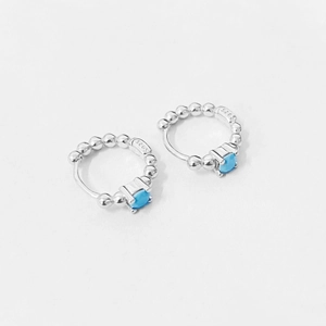Close-up of S925 sterling silver hoop earrings with blue zircon and beaded edges