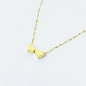 Elegant gold double heart pendant necklace with minimalist fine link chain for women