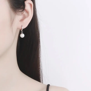 Elegant S925 sterling silver pearl hoop earrings with zircon accents on model