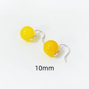 Macro detail of 10mm yellow agate bead earrings with elegant S925 silver hooks