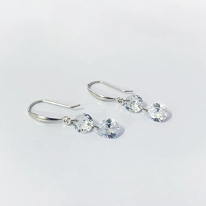 Close-up of S925 sterling silver earrings with round and teardrop-shaped zircon stones