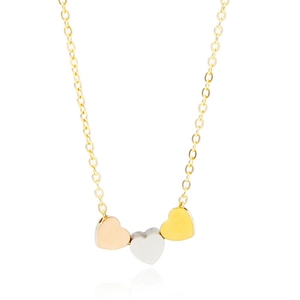 Detailed shot of triple heart pendants in rose gold, silver, and gold on a thin chain