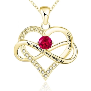 Macro shot of gold heart necklace with red ruby stone and forever engraved text