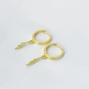 Close-up of gold lightning bolt charm huggie earrings made of S925 sterling silver