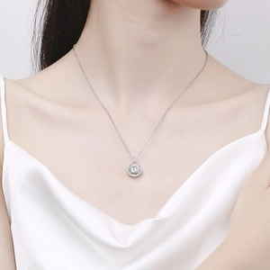 Elegant S925 sterling silver necklace with a round zircon pendant on a female model
