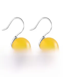 Detail of yellow agate pendant earrings with polished S925 sterling silver hooks
