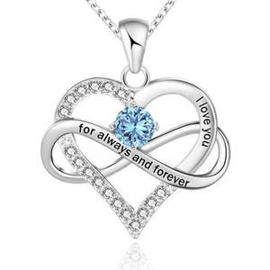 Close-up of 925 sterling silver infinity heart pendant with blue gemstone and engravings