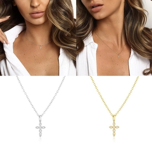 Macro detail of gold and silver cross necklaces featuring sparkling cubic zirconia stones