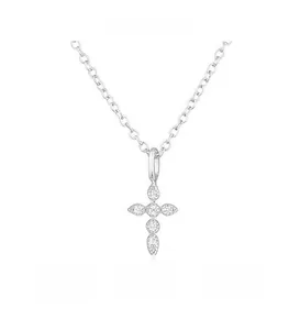 Macro shot of silver cross pendant with sparkling clear round-cut cubic zirconia stones