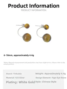 Macro shot of 925 silver earrings with tiger eye beads and platinum plating details